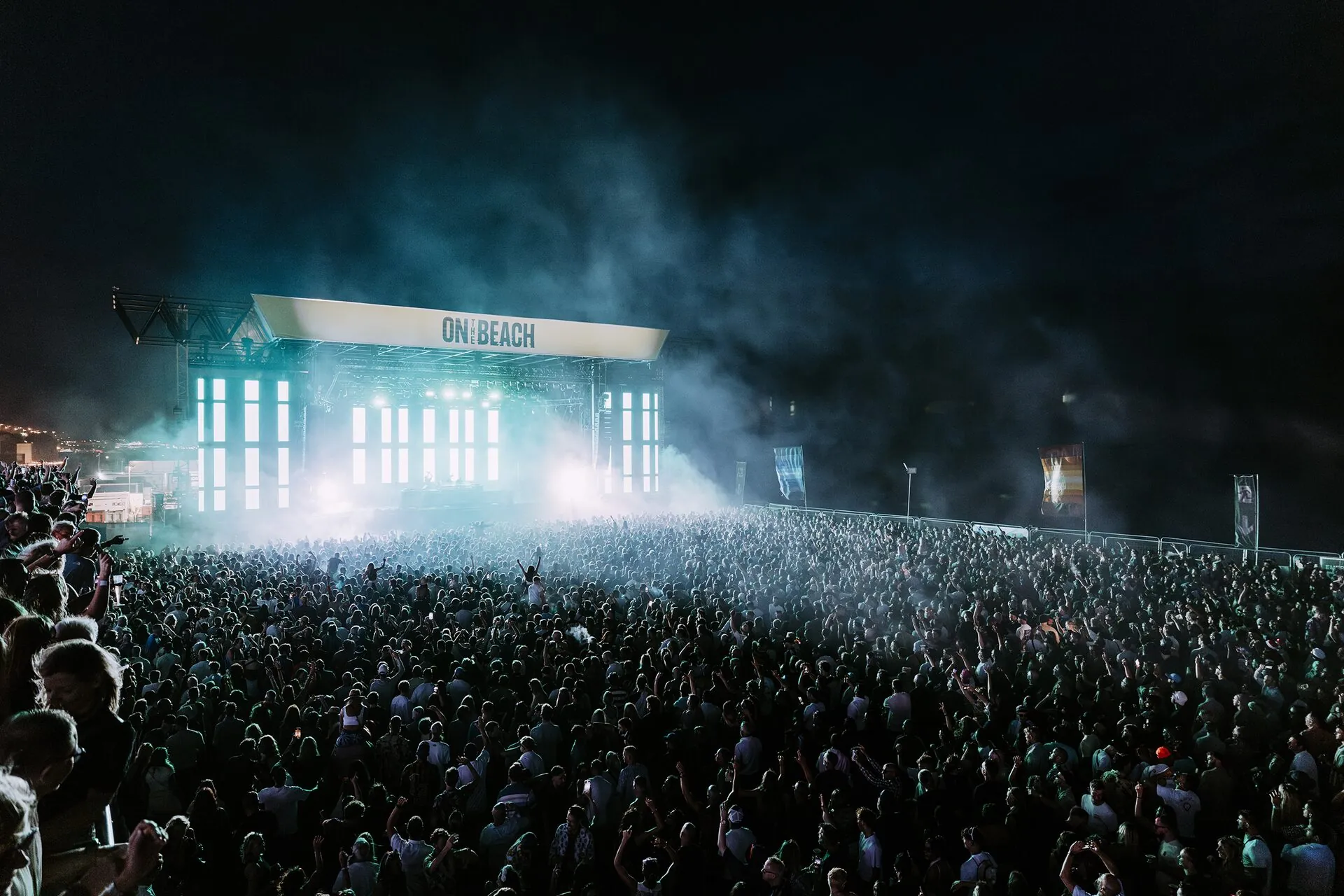 Crowd with hands up at beach concert